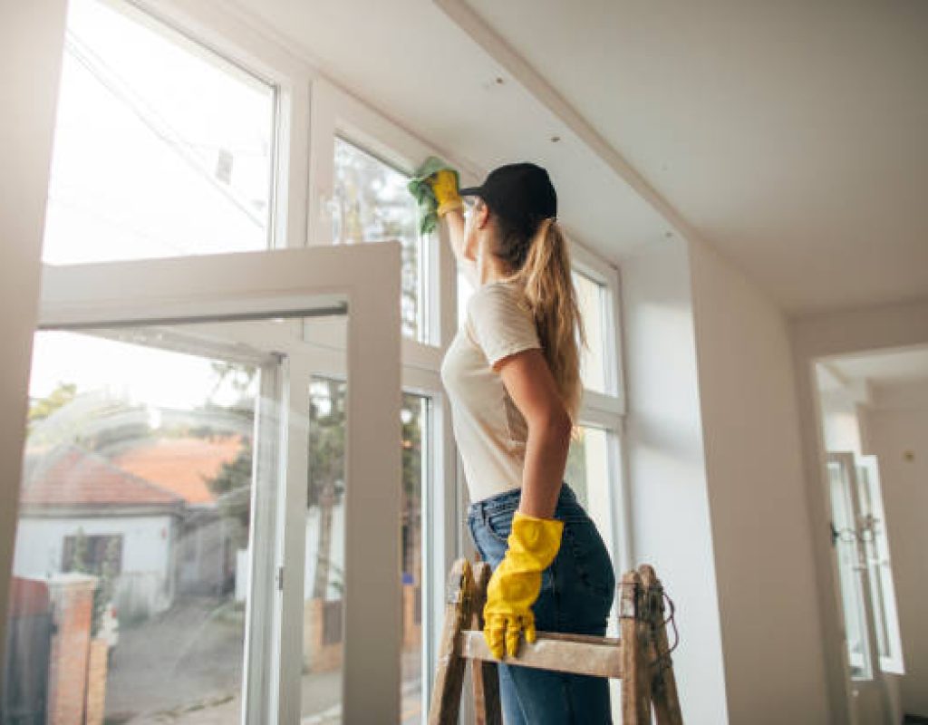 Reliable house cleaning service team cleaning modern living room efficiently